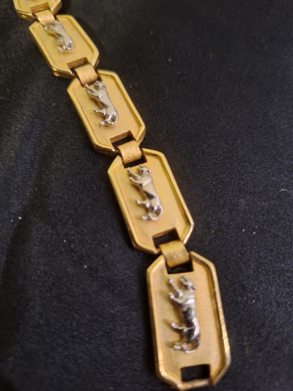 Gold-Tone Linked Bracelet with Silver Panthers. 7"
